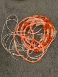 Orange waist bead with glow in the dark butterflies on there 50 inches long tie on